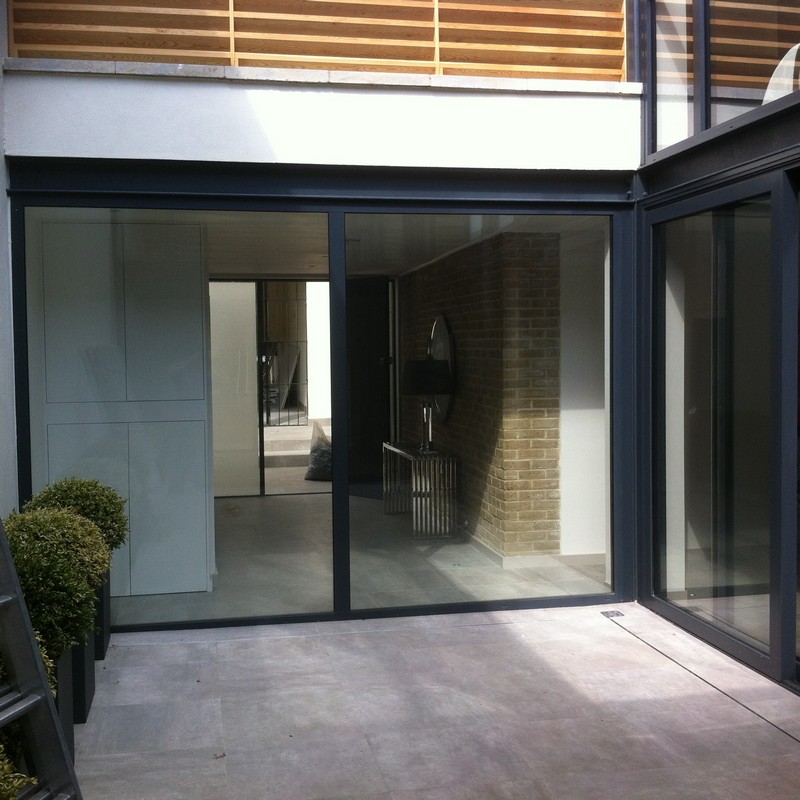 Floor-to-ceiling sliding doors opening to courtyard in Putney