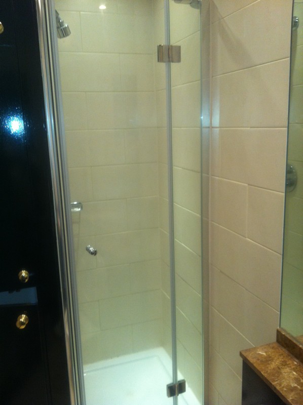 Frameless glass shower enclosure with chrome fittings in Putney
