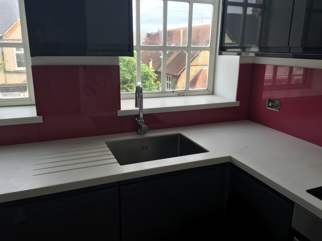 Deep plum coloured glass splashback in modern Putney kitchen