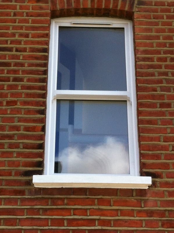 uPVC sash window on Victorian red brick house in Putney